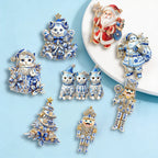 Wuli&baby Blue-and-white Porcelain Design Christmas Brooches For Women Tree Cats Santa Claus Nutcracker New Year Brooch Pins